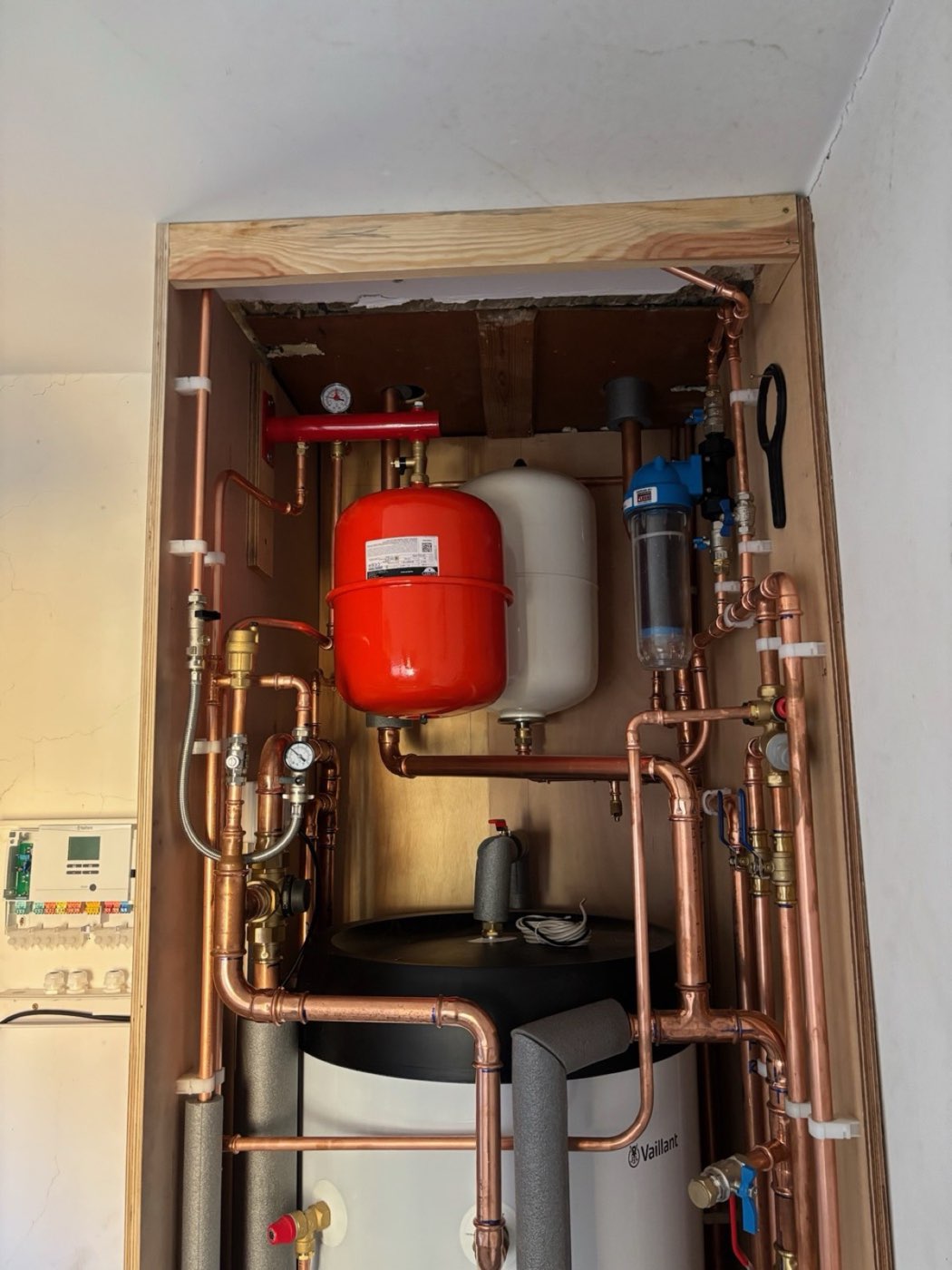 Soldered copper pipework and cylinder in an airing cupboard