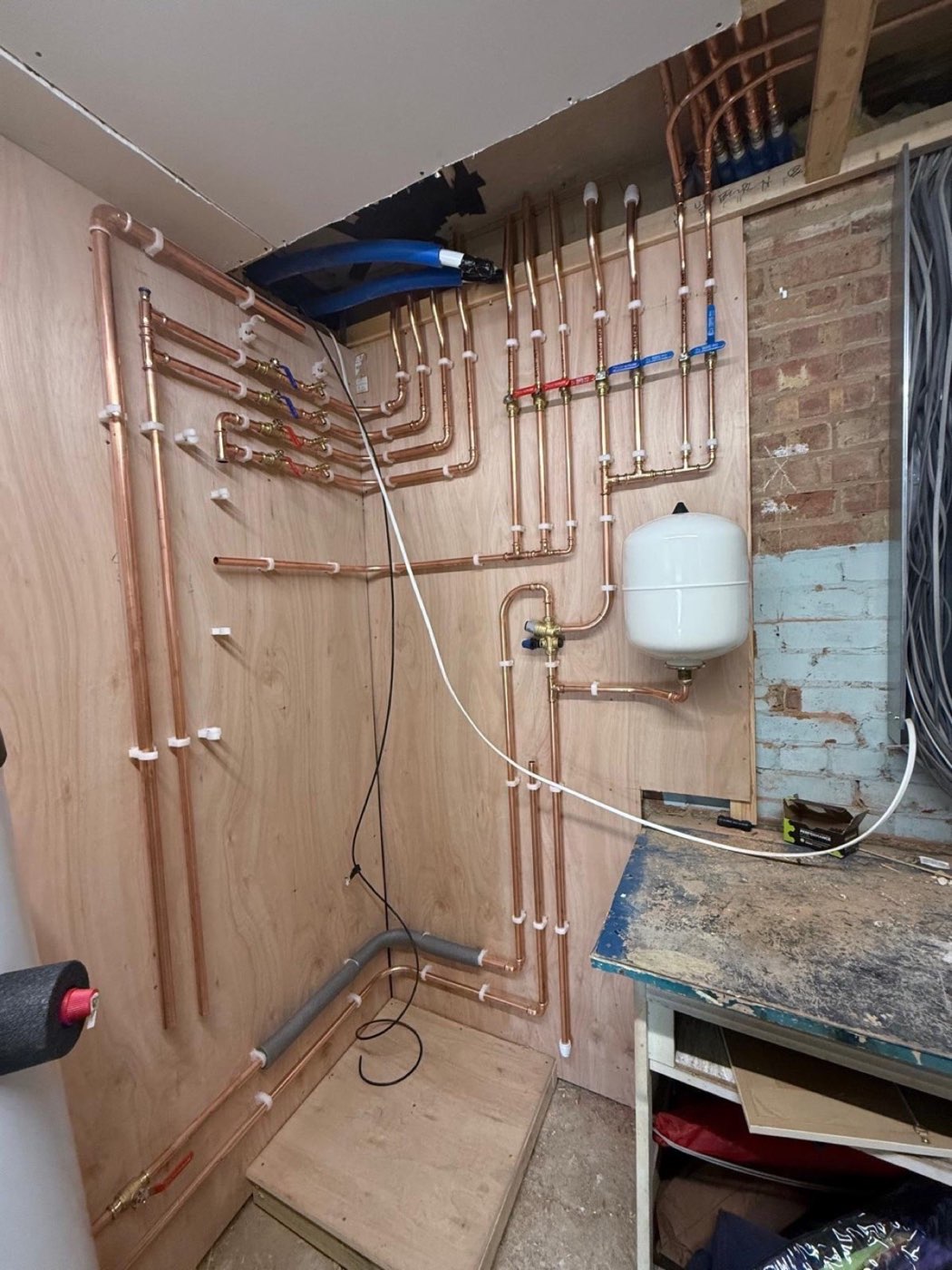 First-fix copper pipework across a plant room wall
