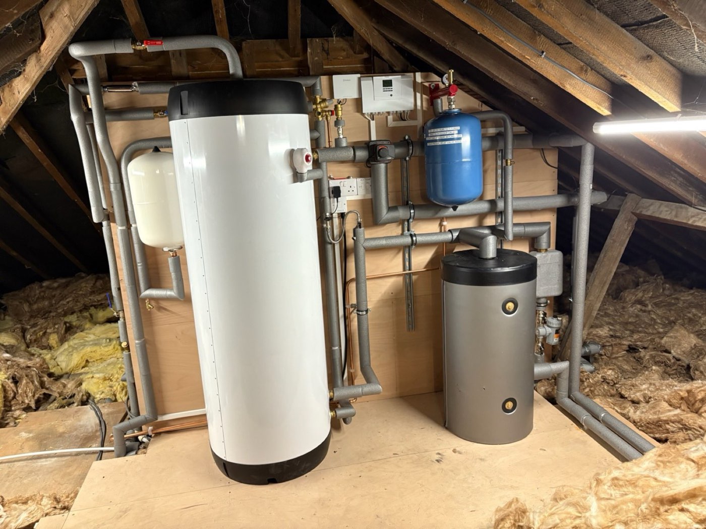Loft hot water cylinder installation between rafters
