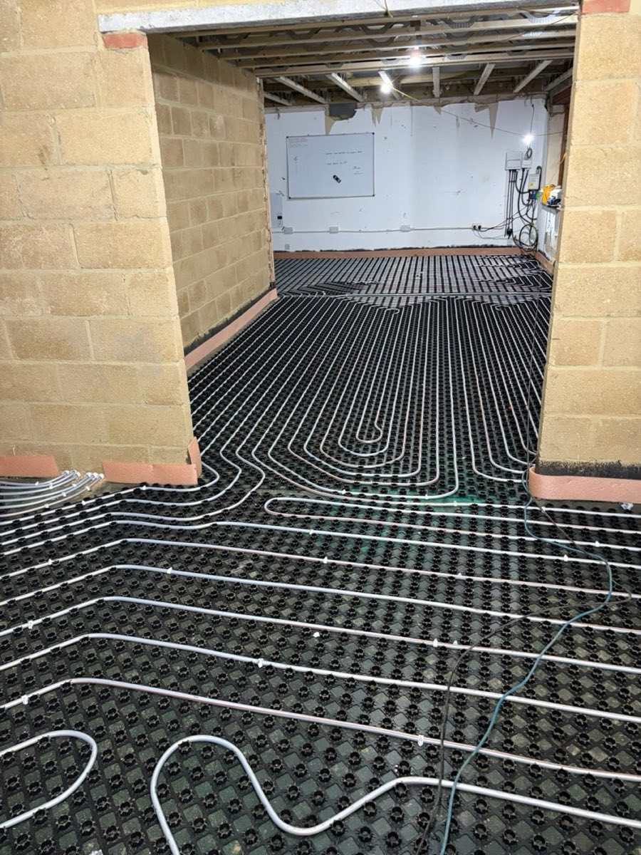 Underfloor heating pipe loops laid on insulation panels