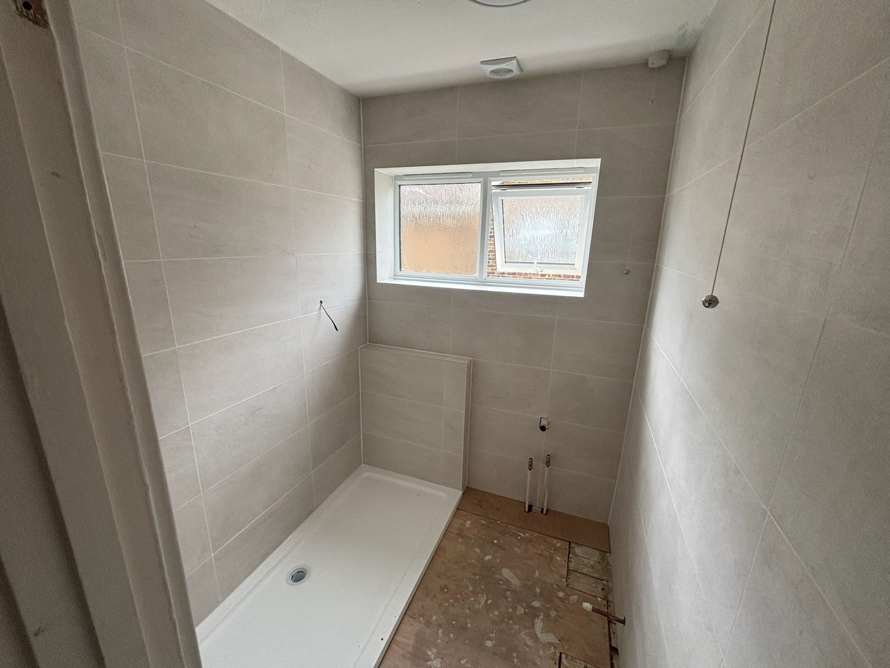Finished tiled shower room with new shower tray, installed by Smith's Heating Services