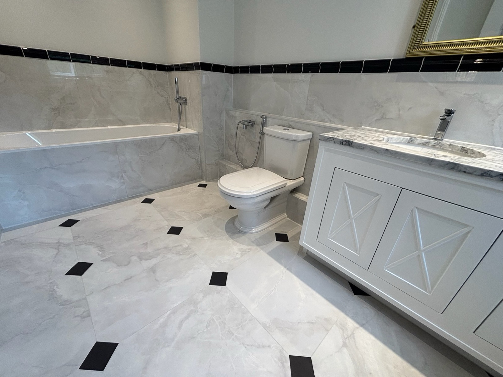 Marble bathroom with bath, traditional WC and twin marble-top vanity